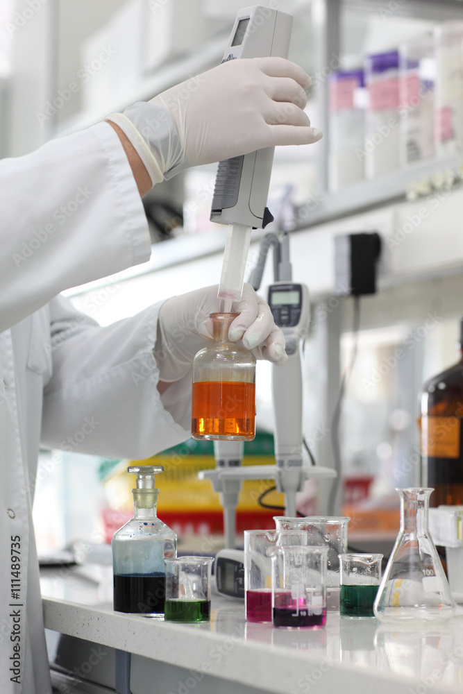 professional working with pipette and test tubes in laboratory - close up professional working with pipette and test tubes in laboratory - close up
