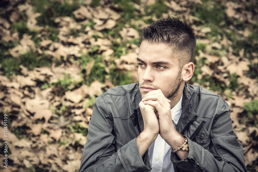 Portrait of man sitting in park Portrait of man sitting in park