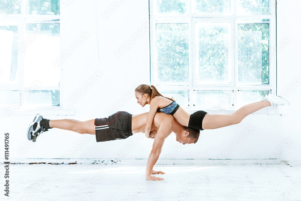 The fit woman and man doing some push ups at the gym The fit woman and man doing some push ups at the gym