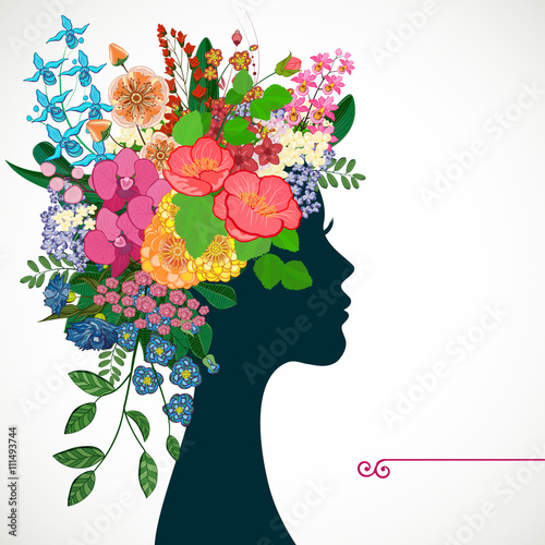 Beautiful profile young woman with tropicl flowers in heir hair.