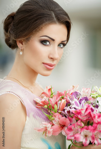 Beautiful woman with flowers outdoor