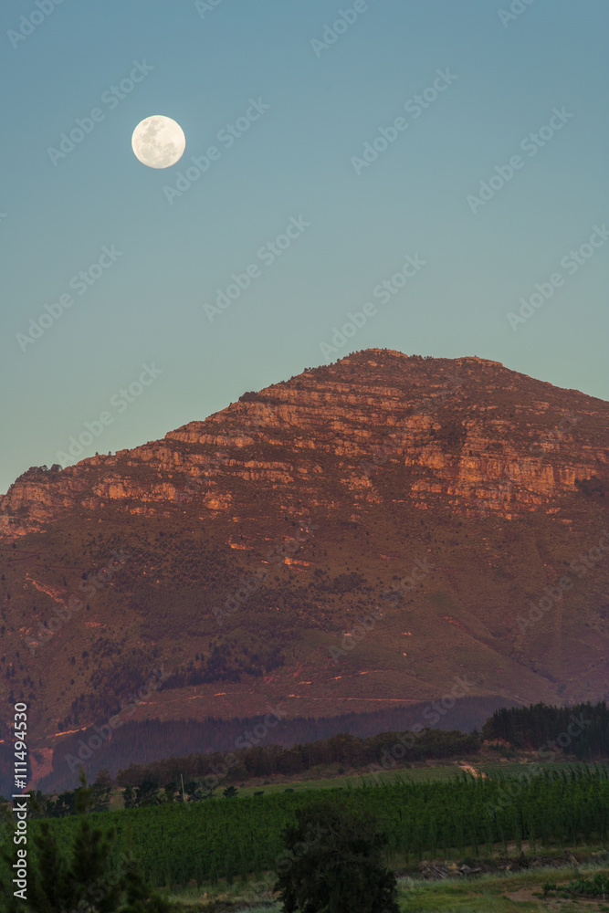 Moon above a mountain at sunset Moon above a mountain at sunset