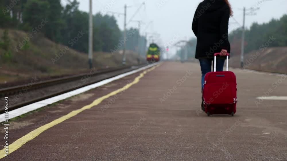 Girl at the Train Station Walking Along the Platform