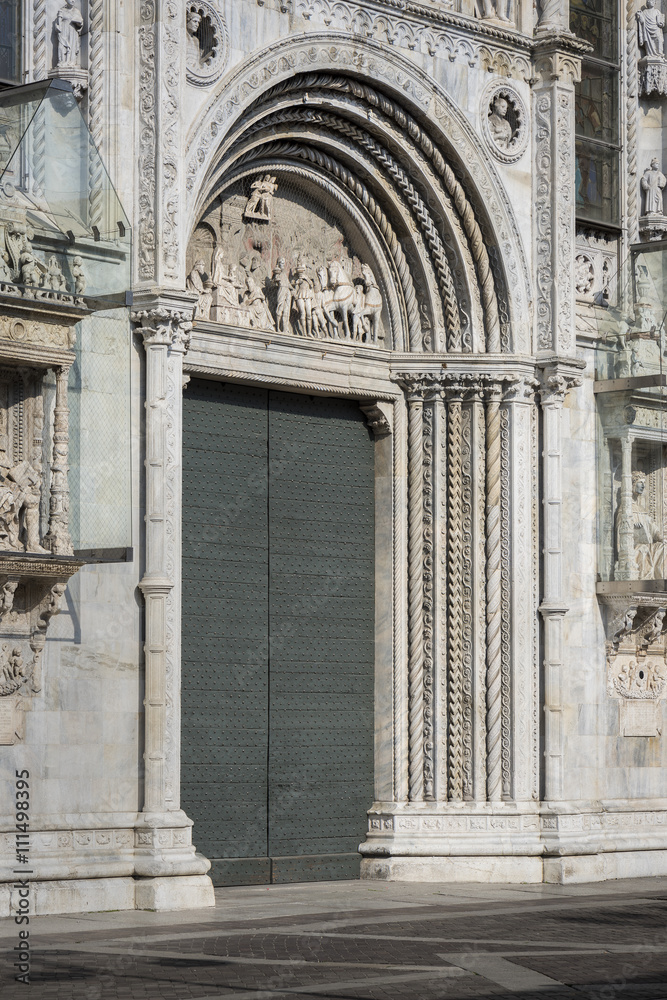 Late Gothic Church Door: The ornately decorated Marble door to the Duomo di Como in Como, Italy