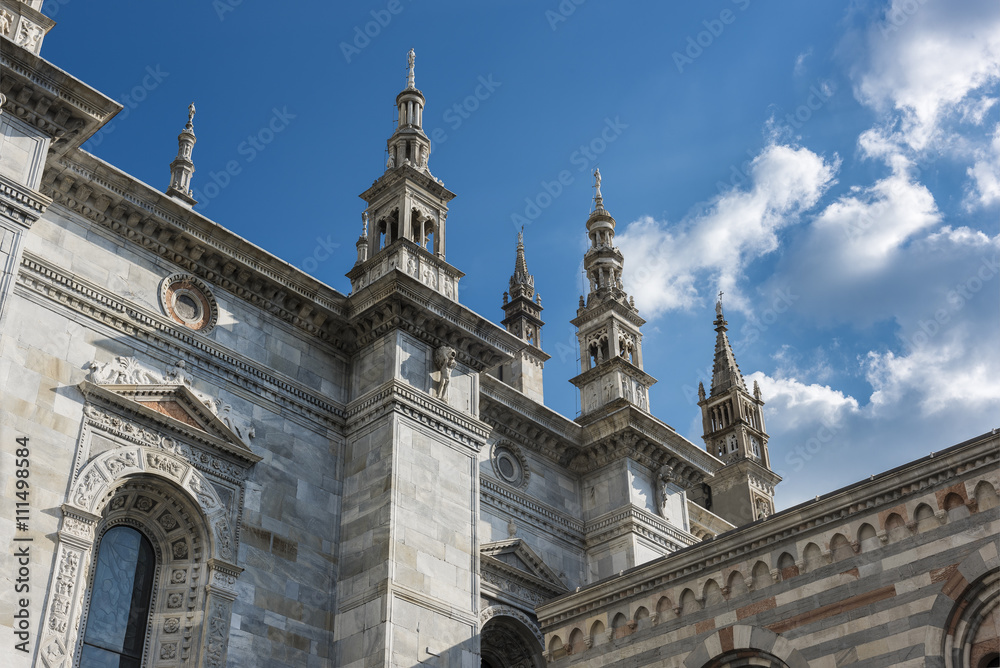 Cathedral Spires of Como, Italy: The ornate late Gothic spires of the Duomo in Como rise into a beautiful blue and white sky of spring