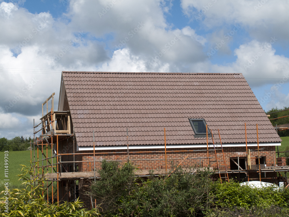 Scaffolding to the side of a new build residential house Scaffolding to the side of a new build residential house