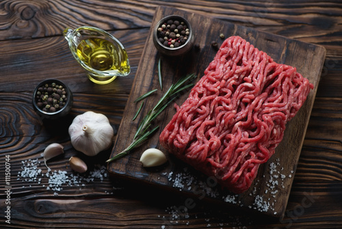 Raw fresh ground beef meat with seasonings, high angle view