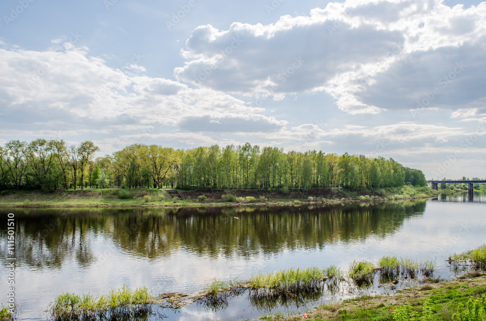 View above big beautiful river with blue sky and green grass in Belarus, Polotsk.