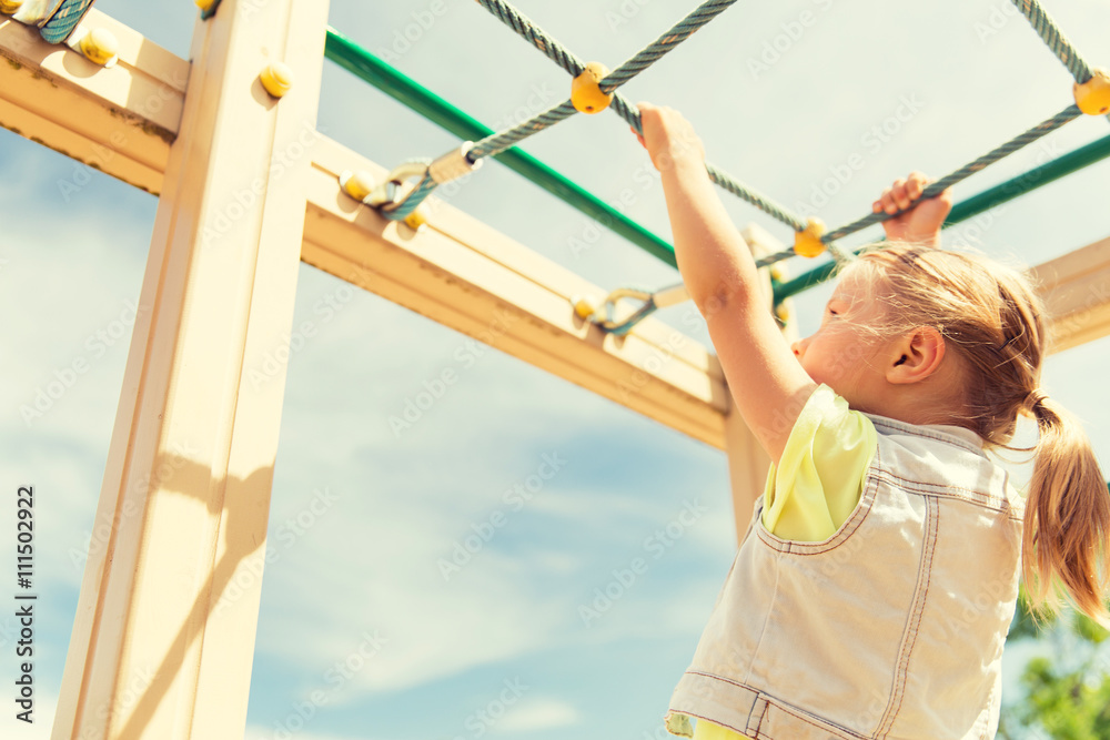 Fototapeta premium close up of girl climbing on children playground