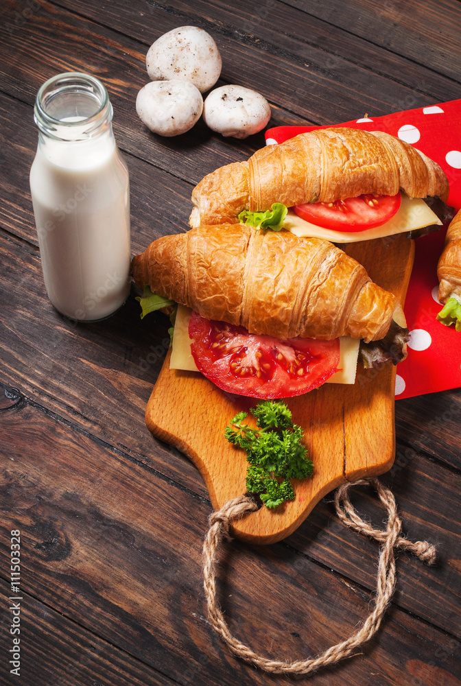 vegetarian croissant cheese breakfast on wood background