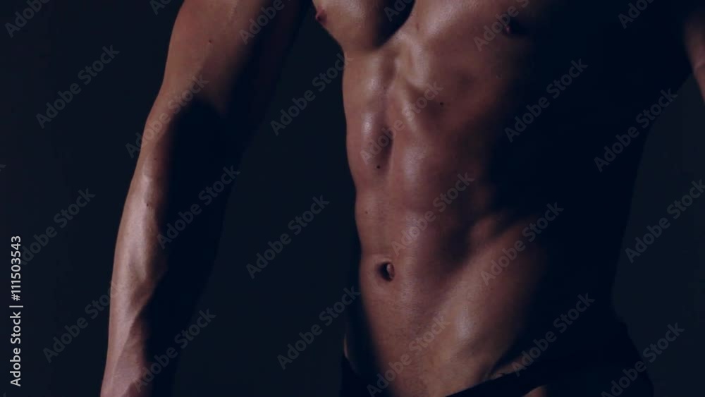 Brutal guy showing his muscles. Abs. Graded Brutal guy showing his muscles. Abs. Graded