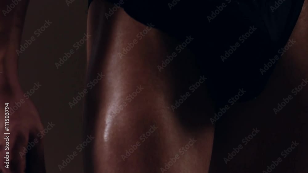 Brutal guy showing his muscles. Quadriceps (leg muscles). Graded Brutal guy showing his muscles. Quadriceps (leg muscles). Graded