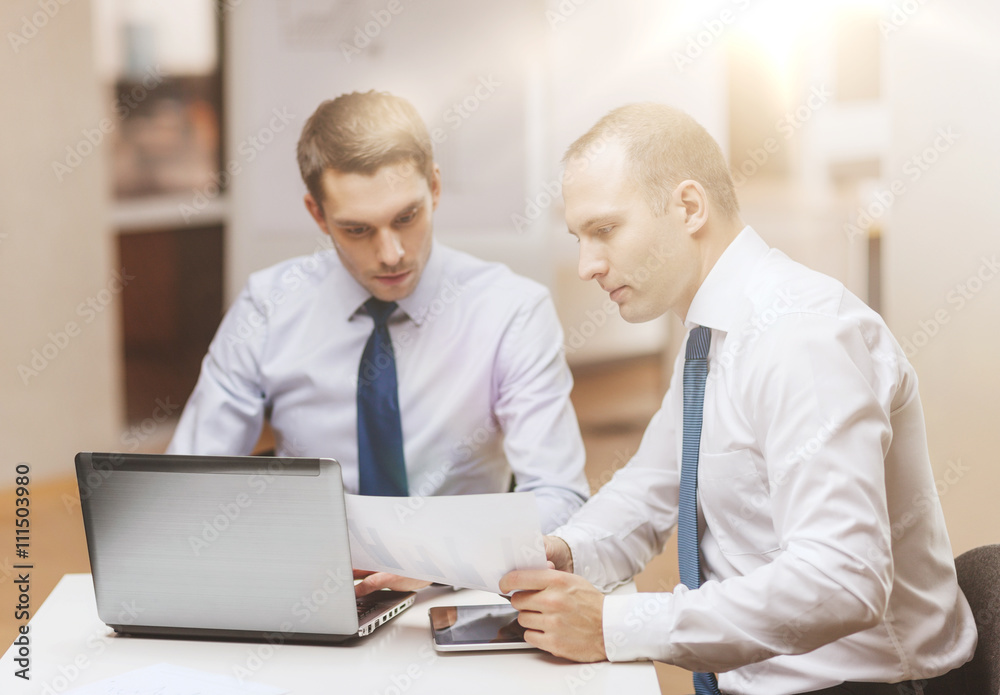 two businessmen having discussion in office two businessmen having discussion in office
