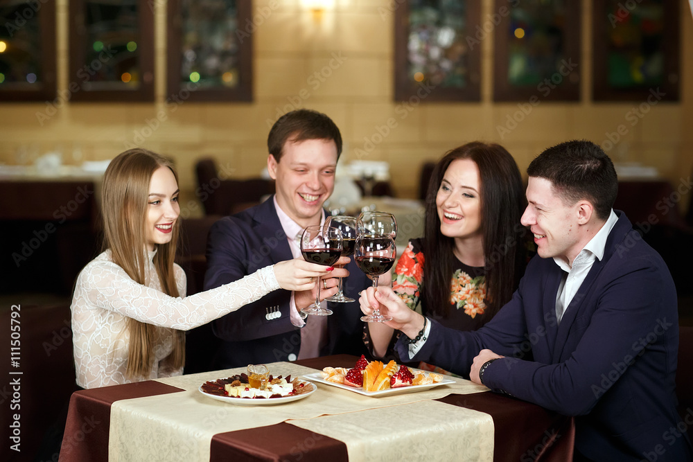 Friends at a restaurant drinking wine.