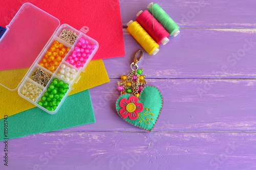 Bright homemade heart with flower. Keychain handmade. Make a heart felt keychain. DIY heart key chain for valentines day. Set kids art