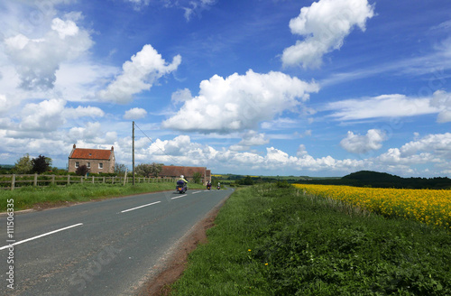 Motorcycle riders on country road.
