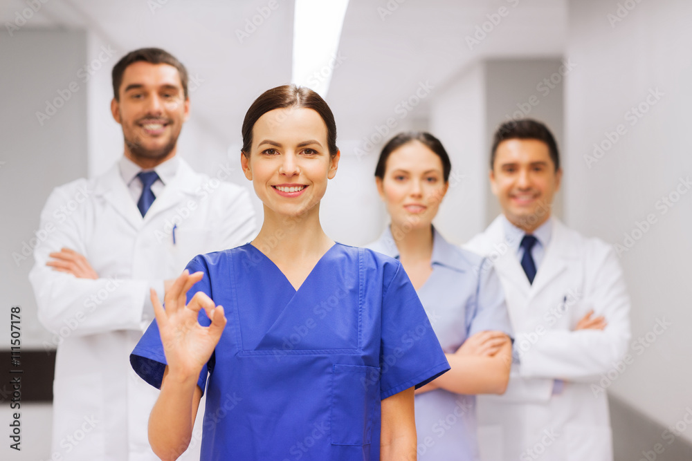 group of medics at hospital showing ok hand sign group of medics at hospital showing ok hand sign