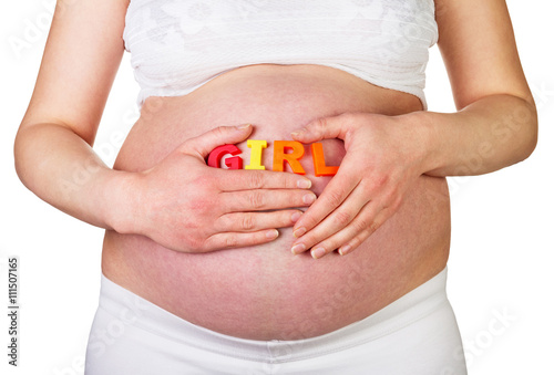 Pregnant woman holding word GIRL is isolated on white background.