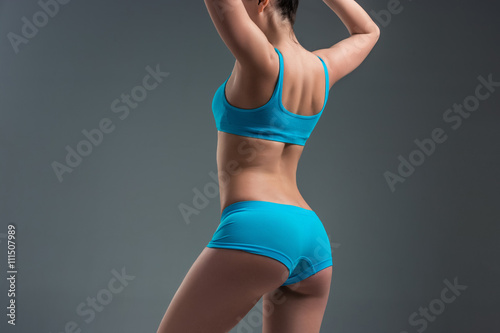 young athletic girl shows muscles