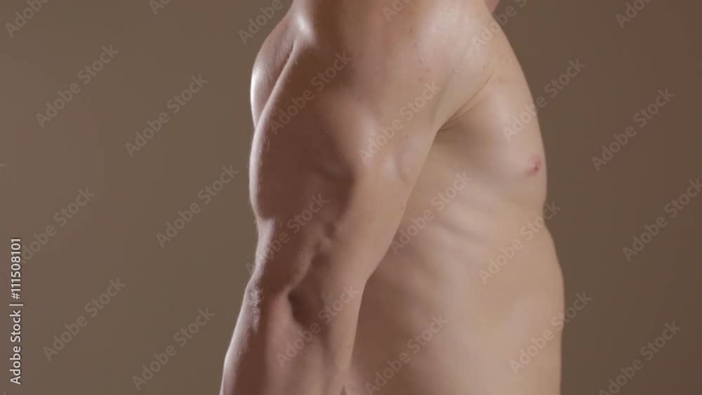 Brutal guy showing his muscles. Triceps. Ungraded Brutal guy showing his muscles. Triceps. Ungraded
