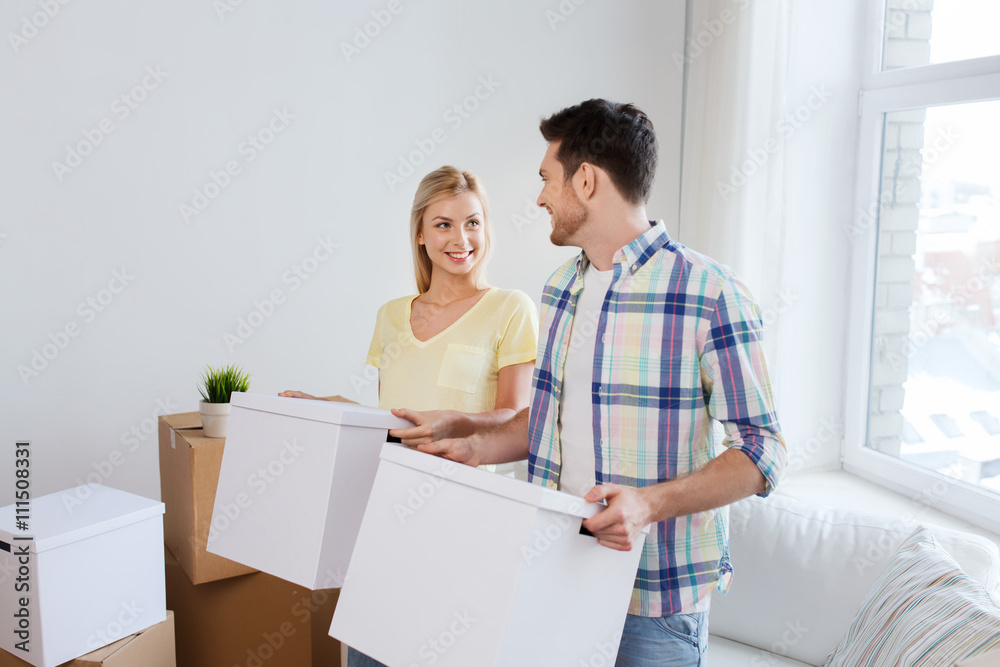 smiling couple with big boxes moving to new home smiling couple with big boxes moving to new home