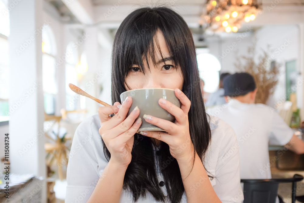 Beautiful woman with coffee cup in coffee shop Beautiful woman with coffee cup in coffee shop
