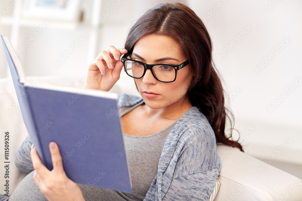 pregnant woman reading book at home