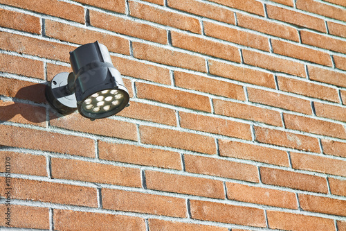 Spotlight against a new brick wall - image with copy space photo