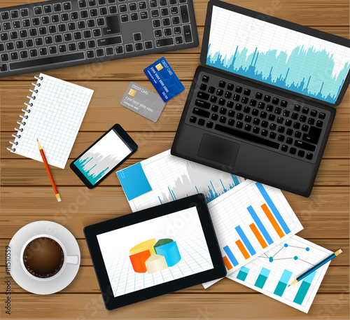 Finance analytic, accounting or businessmen workplace.Top view -laptop with financial graph on screen, tablet, documents, coffee cup, smartphone, credit cards,notepad,pencils