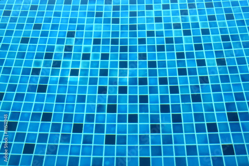 Background of blue tile under clear pool