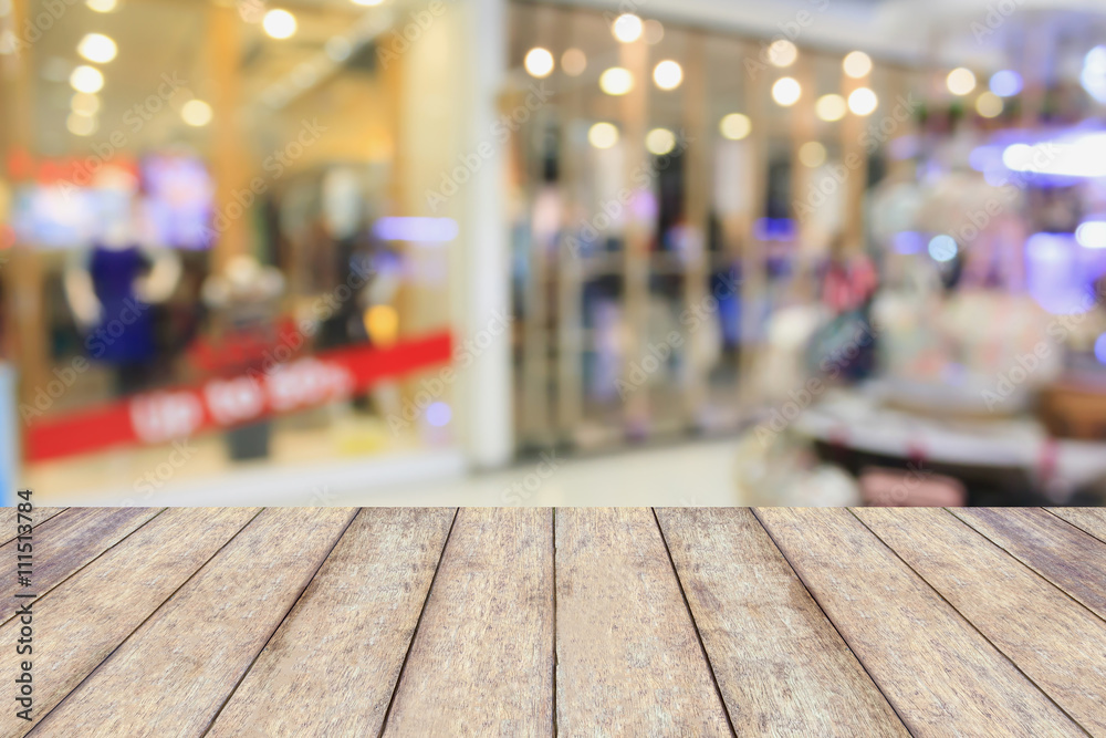 Empty table and blur clothing store with bokeh background Empty table and blur clothing store with bokeh background