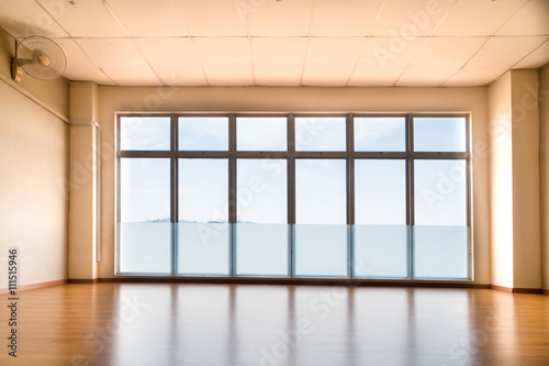 Perspective view of empty studio illuminated with light from win