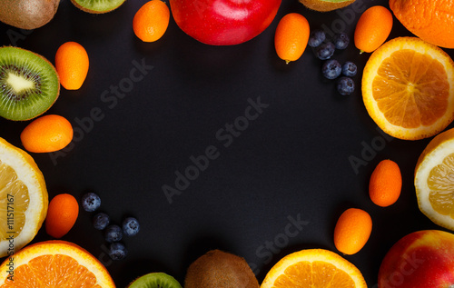 Fresh fruits oranges, kiwi, lemons, apples arranged in a group, natural still life for healthy food. Top view. Empty space for text.