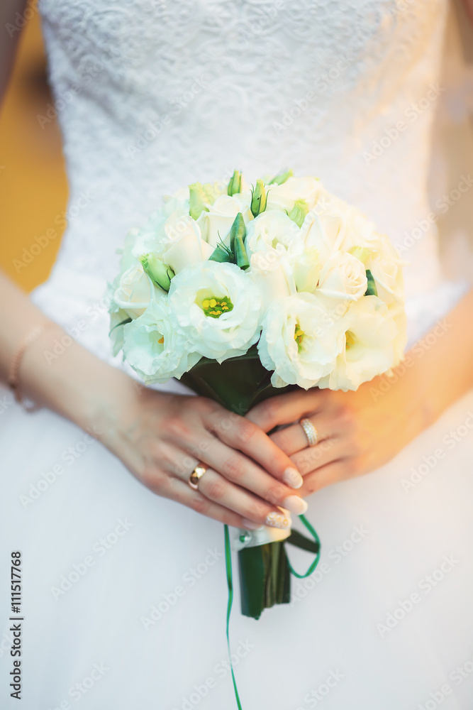 Beautiful wedding bouquet in hands of the bride Beautiful wedding bouquet in hands of the bride