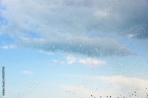 Raindrops on a window.Through the glass sky and clouds