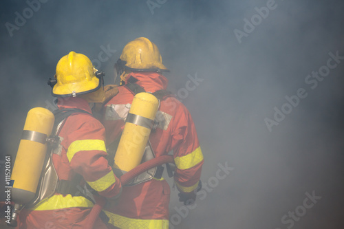 Εκτύπωση καμβά two firefighters is working surround with smoke and dust