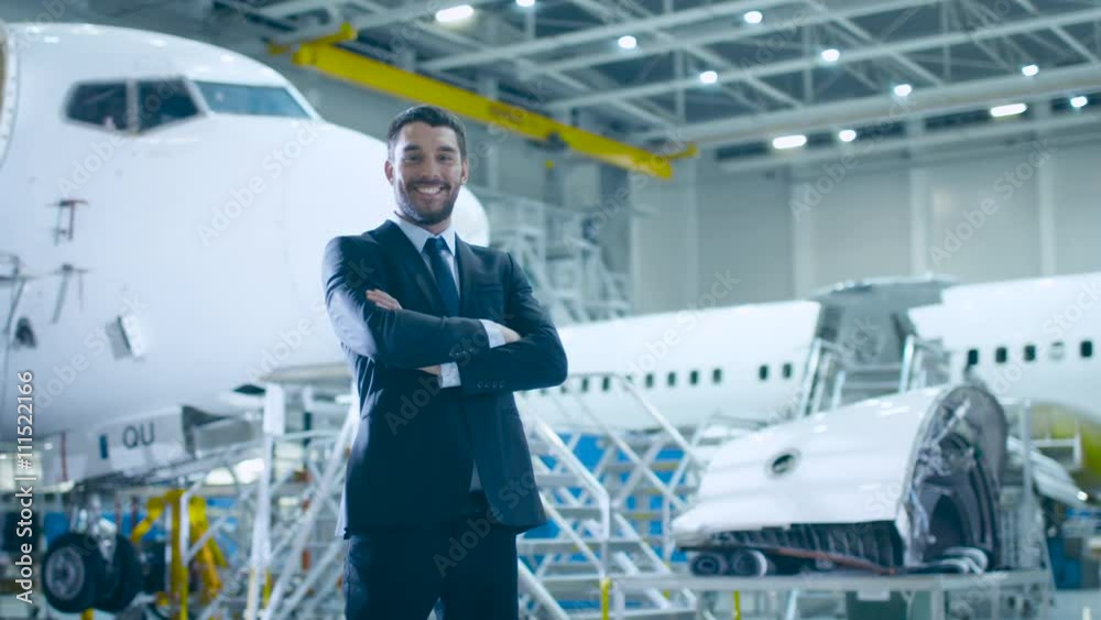Portrait of Businessman in Aircraft Maintenance Terminal. Shot on RED Cinema Camera. Portrait of Businessman in Aircraft Maintenance Terminal. Shot on RED Cinema Camera.