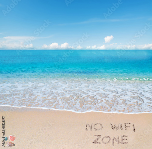 no wifi zone written on a tropical beach