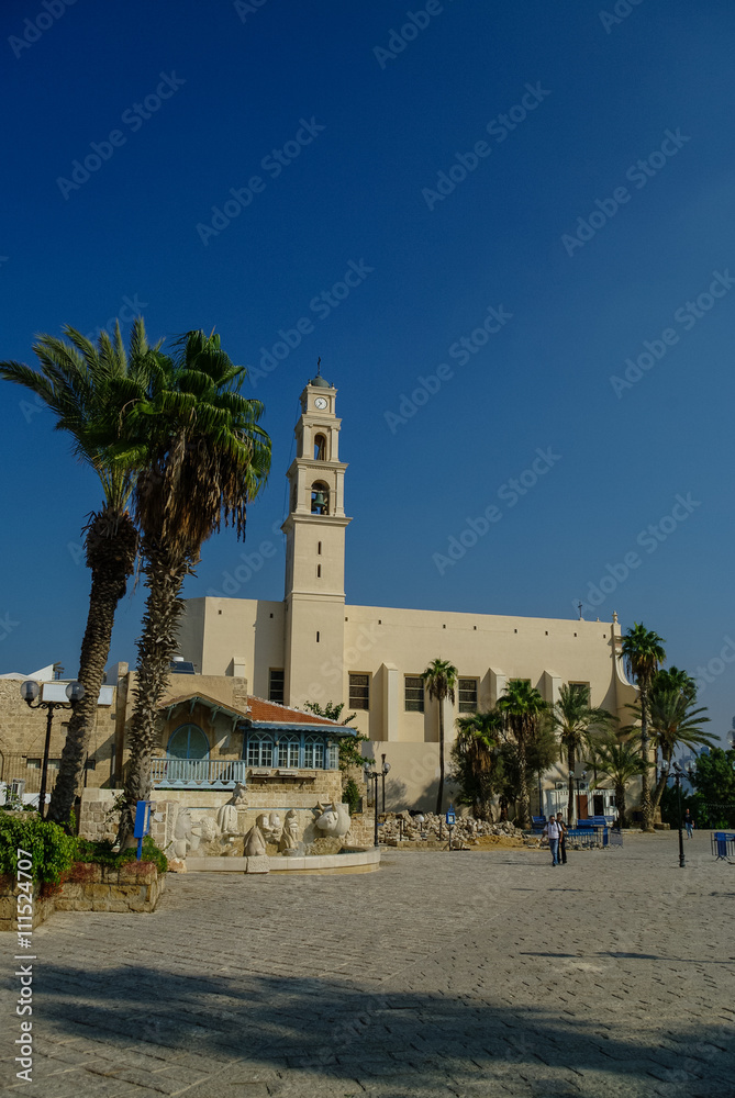 St. Peter's Church. The bell tower with clock of the Church. Sunset light in Jaffa, Israel