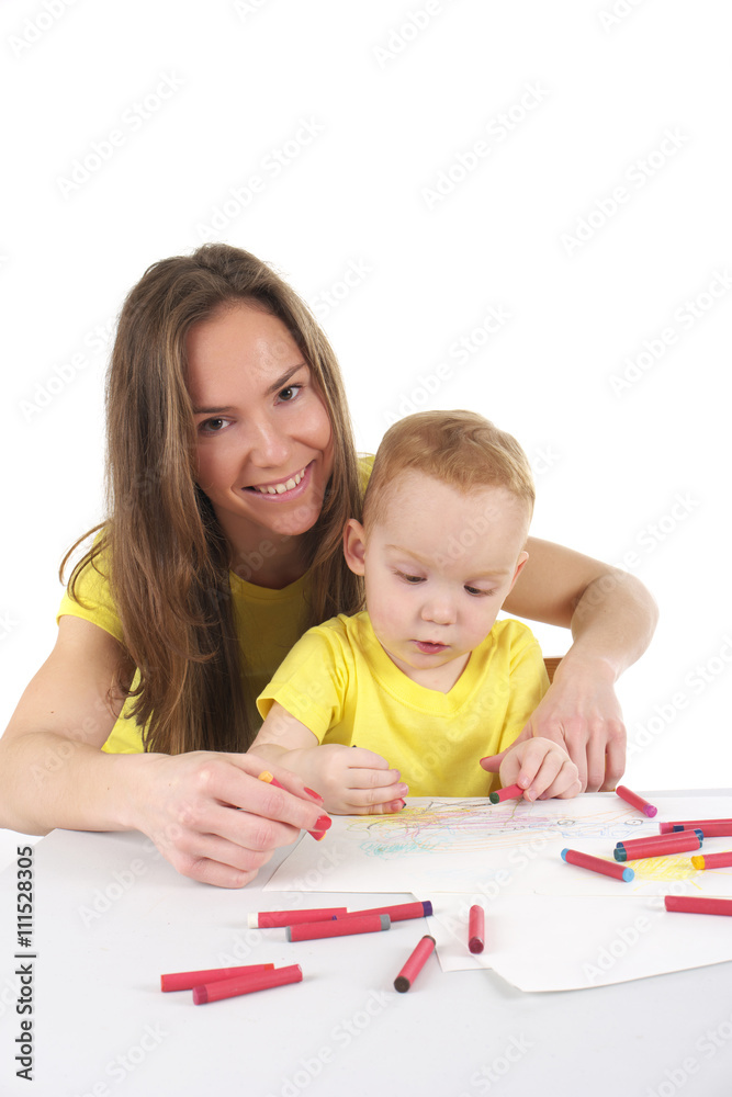 Mother and son are drawing the picture together Mother and son are drawing the picture together