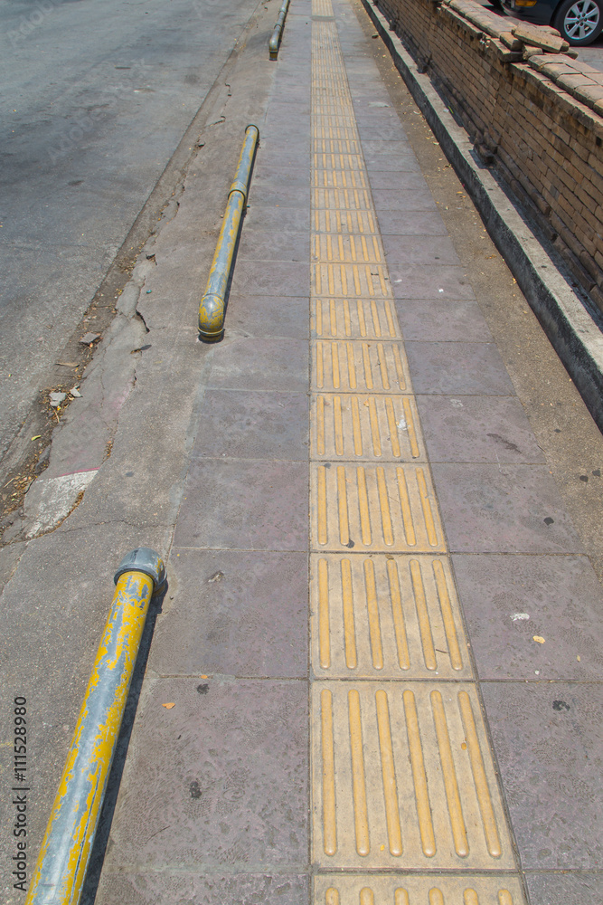 closeup of road with yellow line
