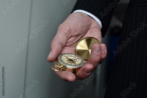  Businessman with a compass holding in hand, color tone film look