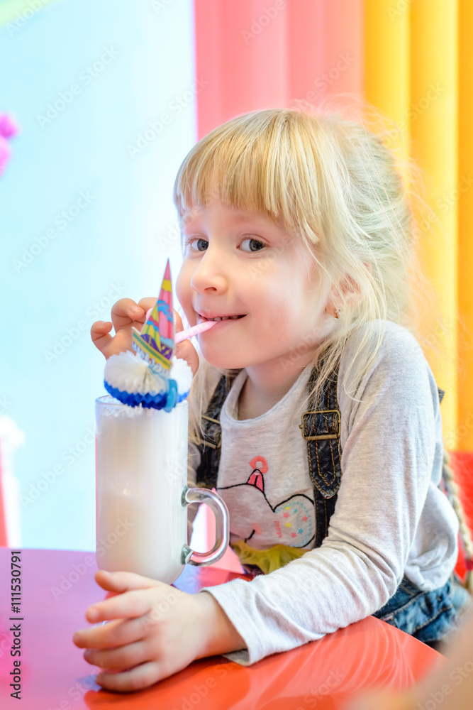 Cute pretty little girl enjoying a milkshake Cute pretty little girl enjoying a milkshake