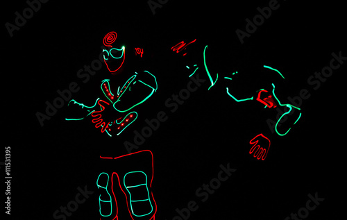 dancers in led suits on dark background, colored show