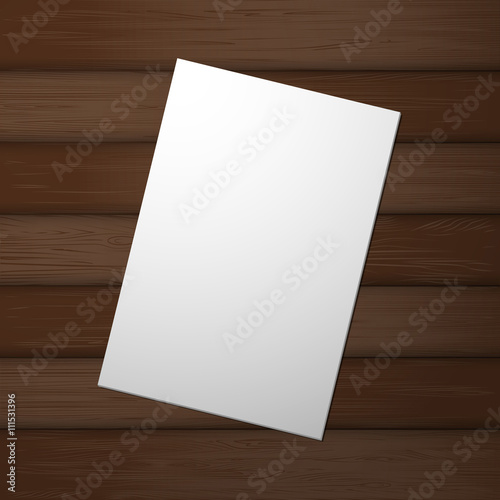A blank sheet of paper on a wooden table top view