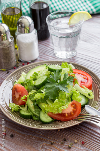 Lettuce, tomato, cucumber, avocado salad for lunch.