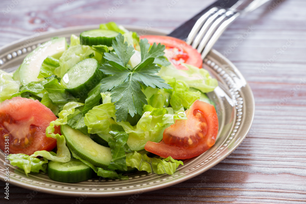 Lettuce, tomato, cucumber, avocado salad for lunch. Lettuce, tomato, cucumber, avocado salad for lunch.