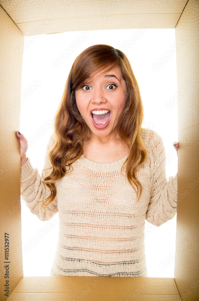 Girl screaming in the border on the cardboard box, white background and hands holding the borders