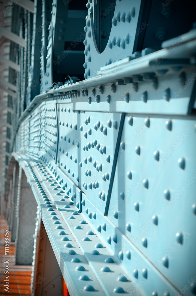 Obraz premium Metal poles pedestrian covered bridge with lots of rivets. Vintage tinted.