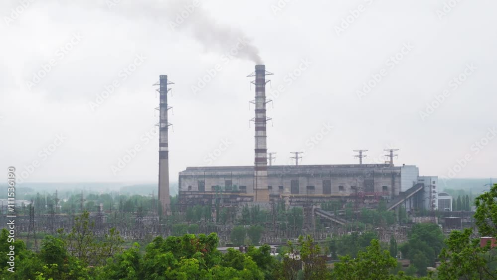 Working coal-fired power plant with high tubes and smoke Working coal-fired power plant with high tubes and smoke